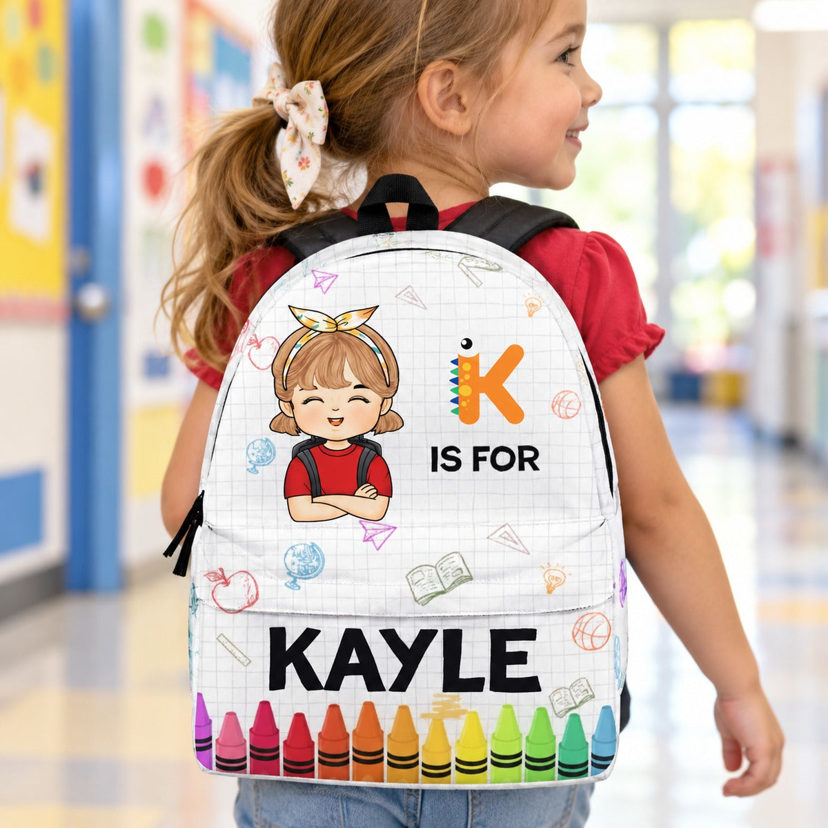 Preschool girl wearing personalized KAYLE monster letter K crayon backpack walking to school