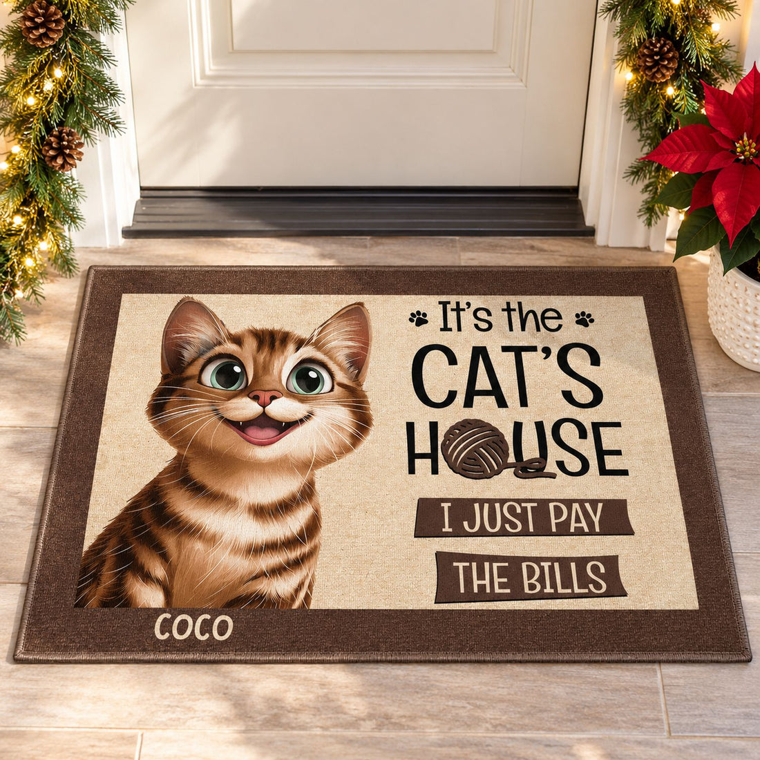 Personalized cat house doormat at a festive Christmas entryway with pine garland