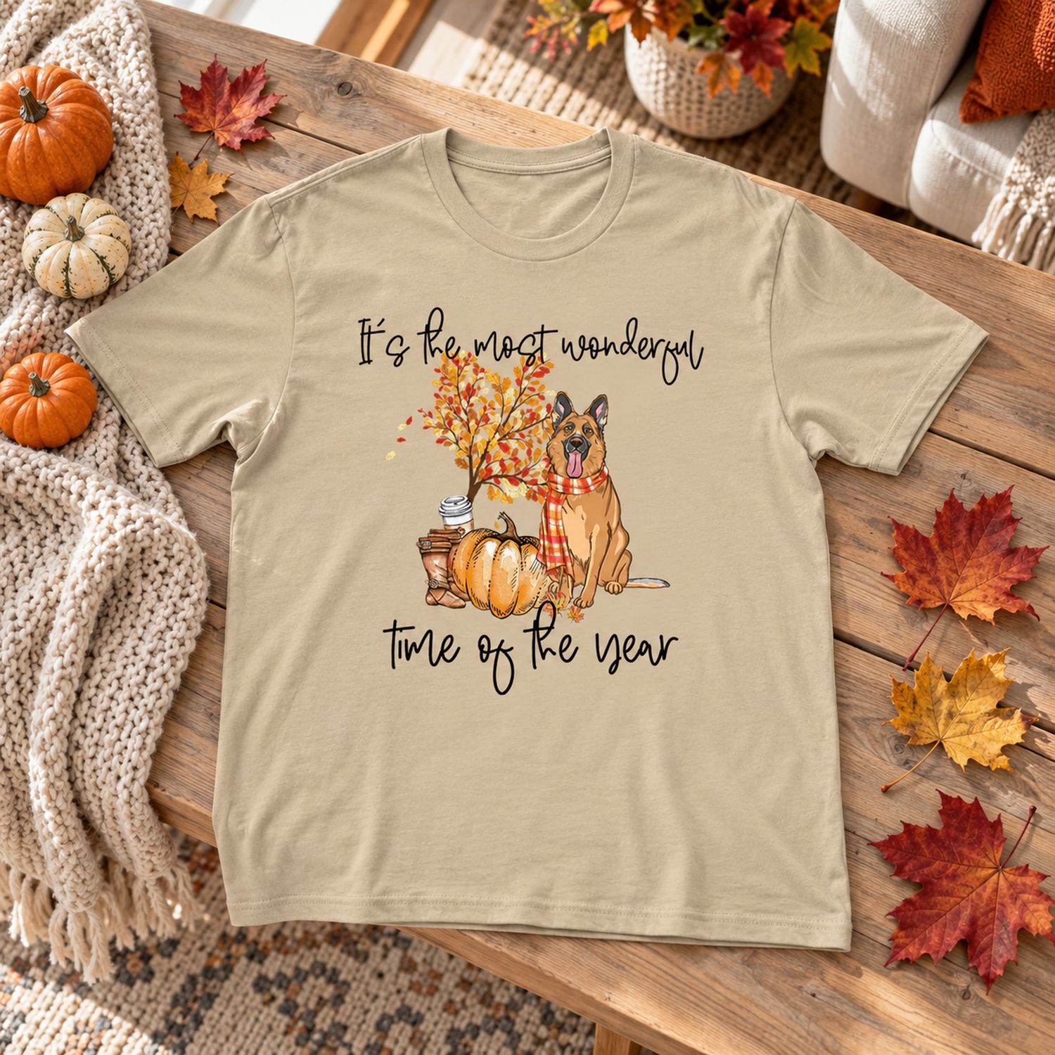 Custom autumn dog lover t-shirt laid flat with pumpkins and fall leaves