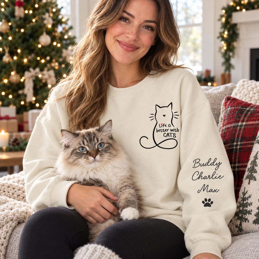 Cat mom wearing personalized Life Is Better With Cats sleeve printed sweater holding a cat by a Christmas tree
