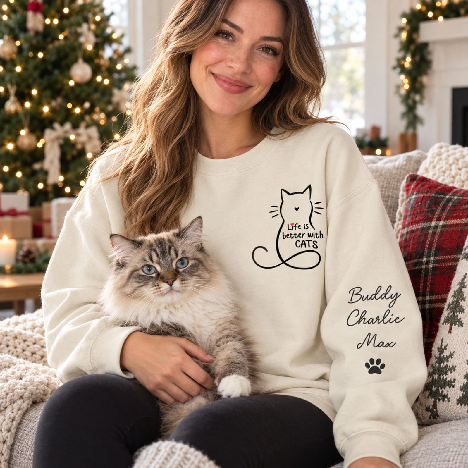 Cat mom wearing personalized Life Is Better With Cats sleeve printed sweater holding a cat by a Christmas tree