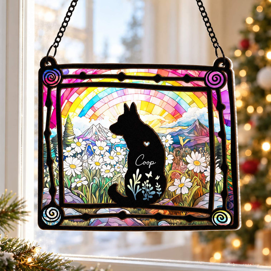 Loss of dog suncatcher ornament hanging by a window with a soft Christmas tree in the background