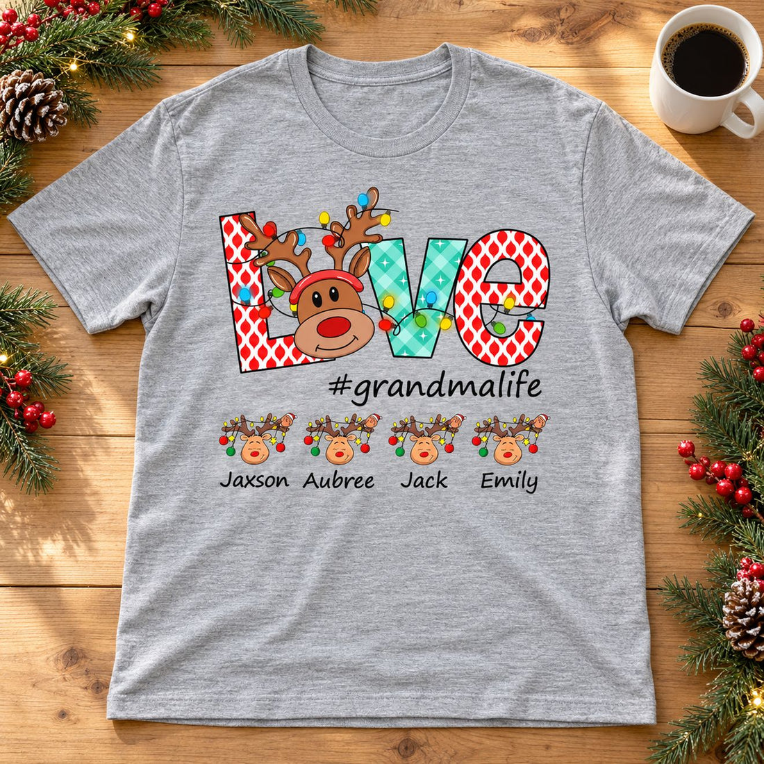 Personalized #grandmalife Christmas reindeer t-shirt laid flat next to holiday pine decor