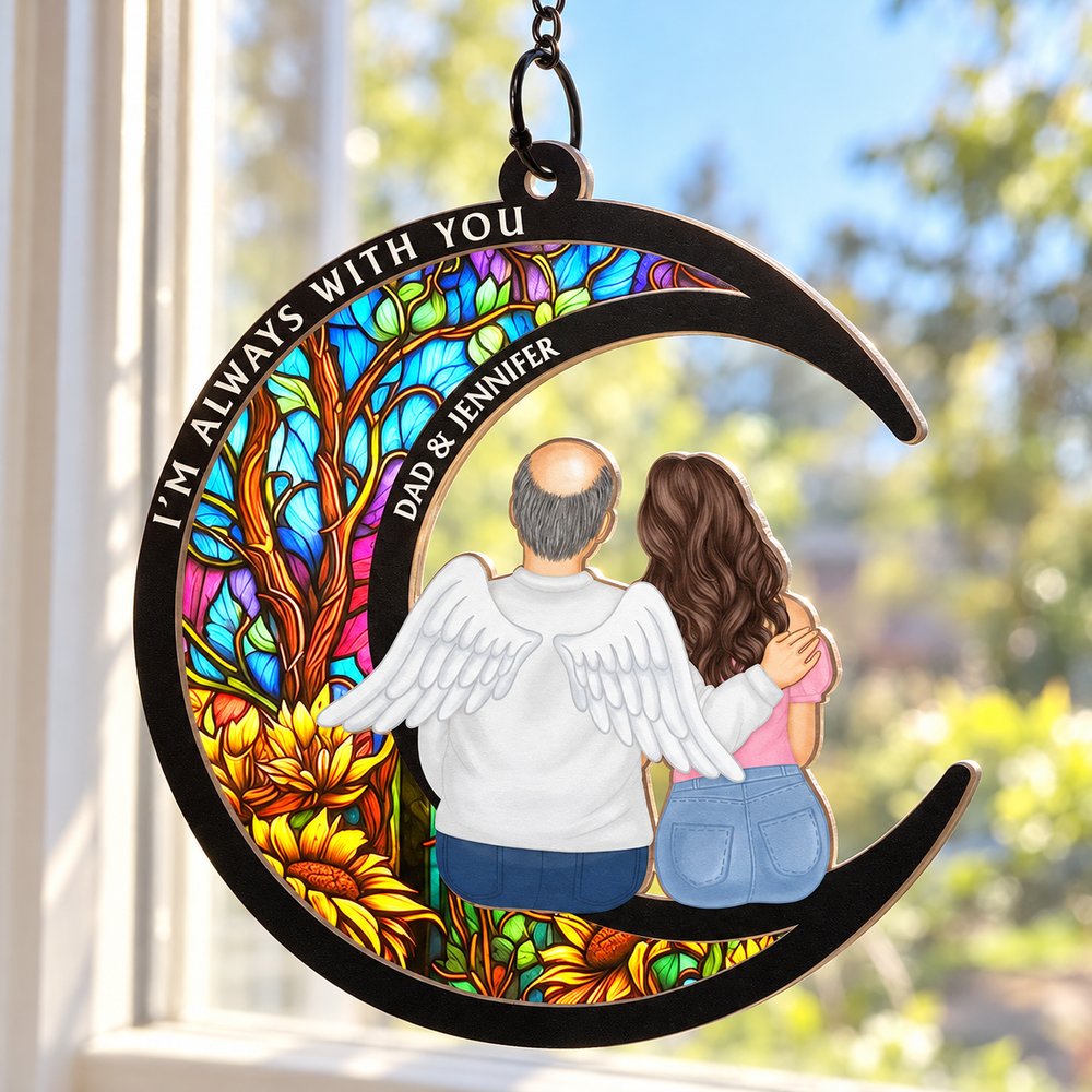 Close-up detail of layered wood and acrylic memorial suncatcher ornament with angel wings