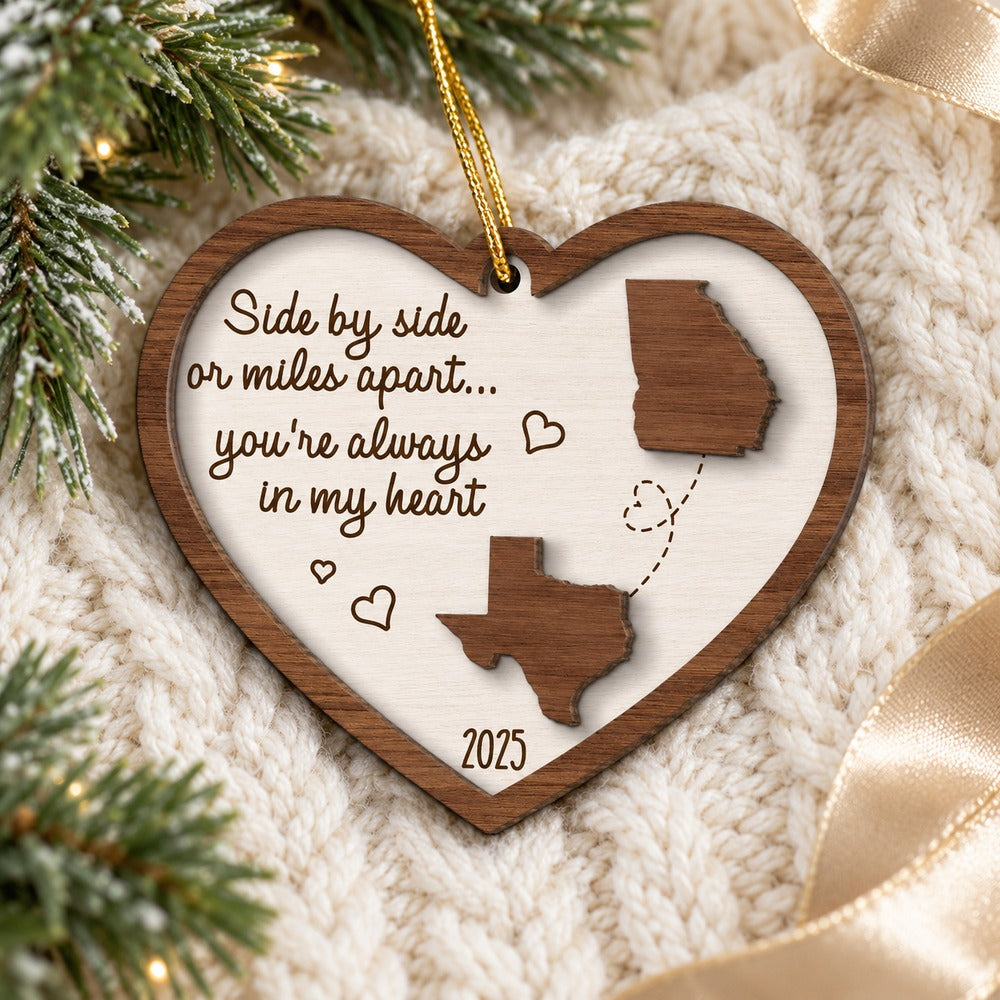 Personalized long distance state map wood ornament lying on cozy holiday knit fabric
