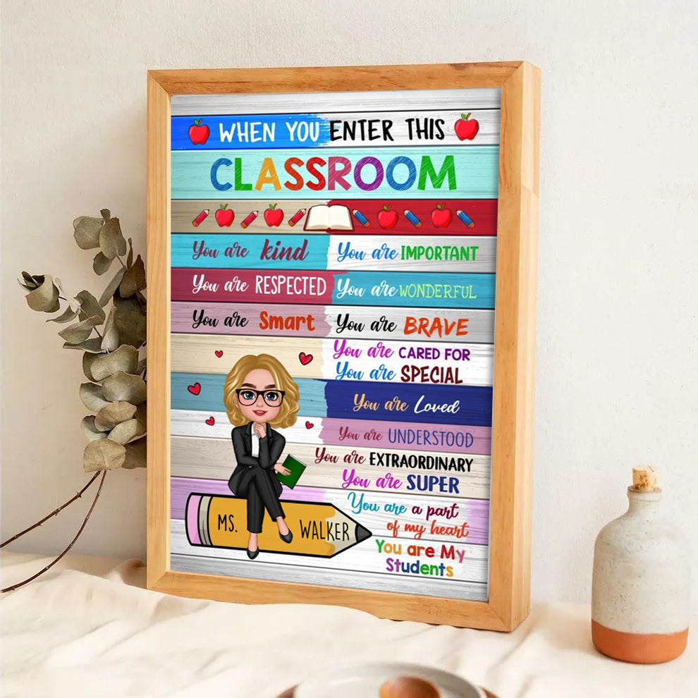 Personalized Colorful Teacher Sitting On Pencil poster, leaning against a wall on a wooden floor