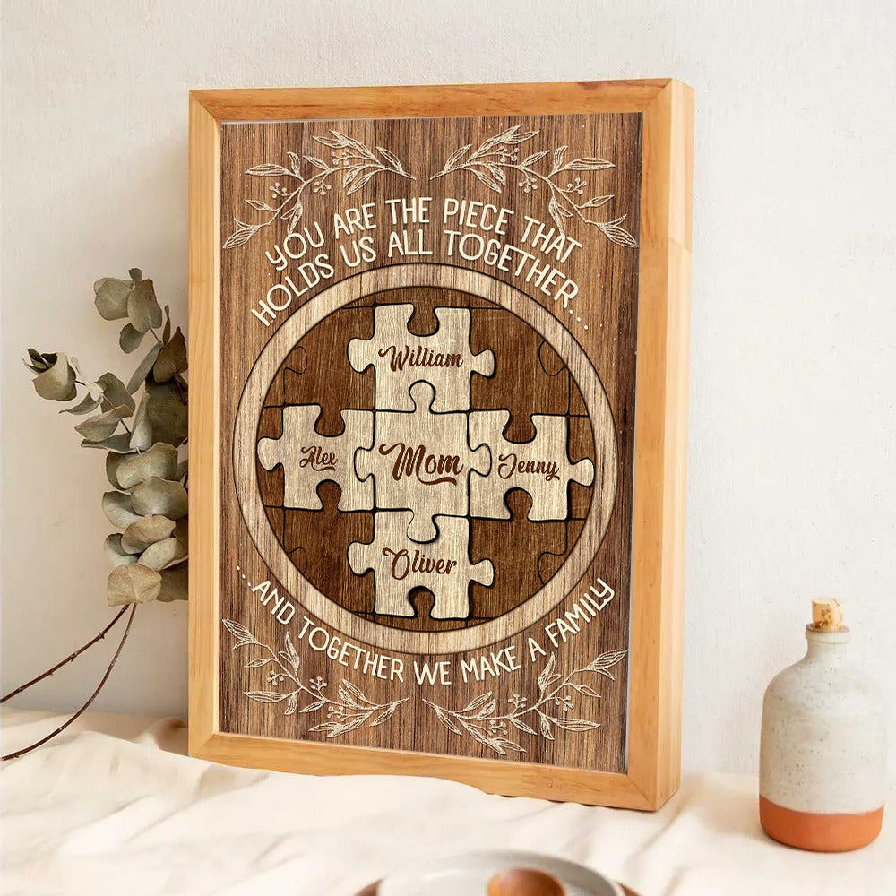 Mom's Custom Puzzle Canvas Print: "You Are The Piece That Holds Us poster, a woman hanging the framed print on a wall