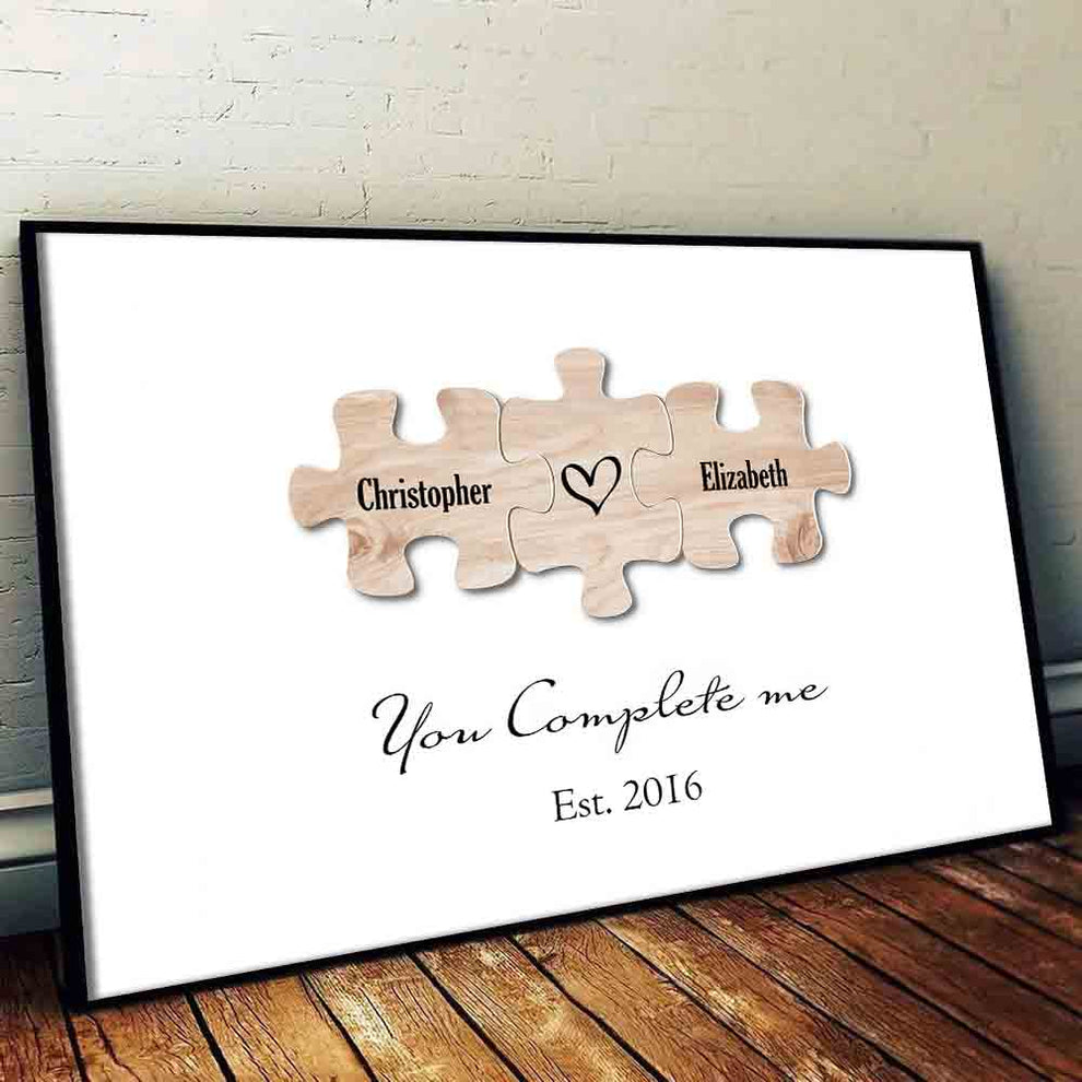 Personalized You Complete Me Couple Puzzle canvas print, leaning against a wall on a wooden floor