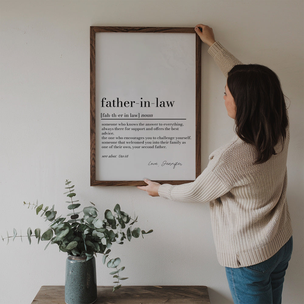 Personalized Father in Law Definition Print poster, a woman hanging the framed print on a wall