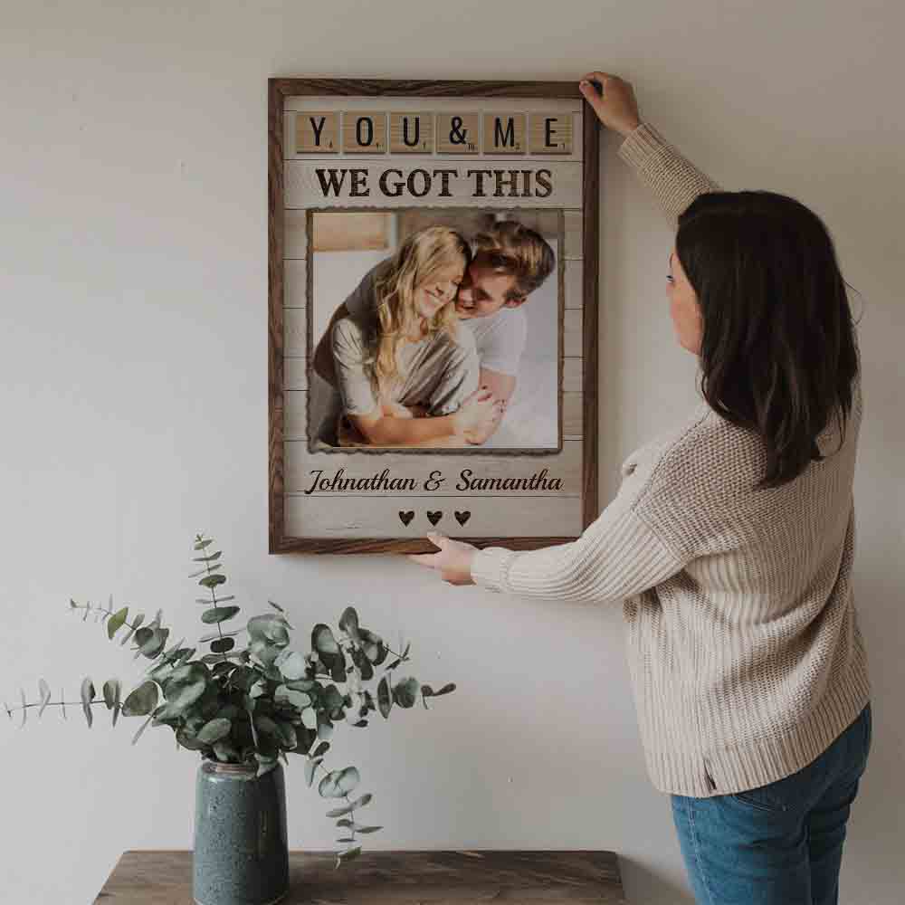 Custom Photo Couple Together Is Our Favorite Place To Be poster, a woman hanging the framed print on a wall