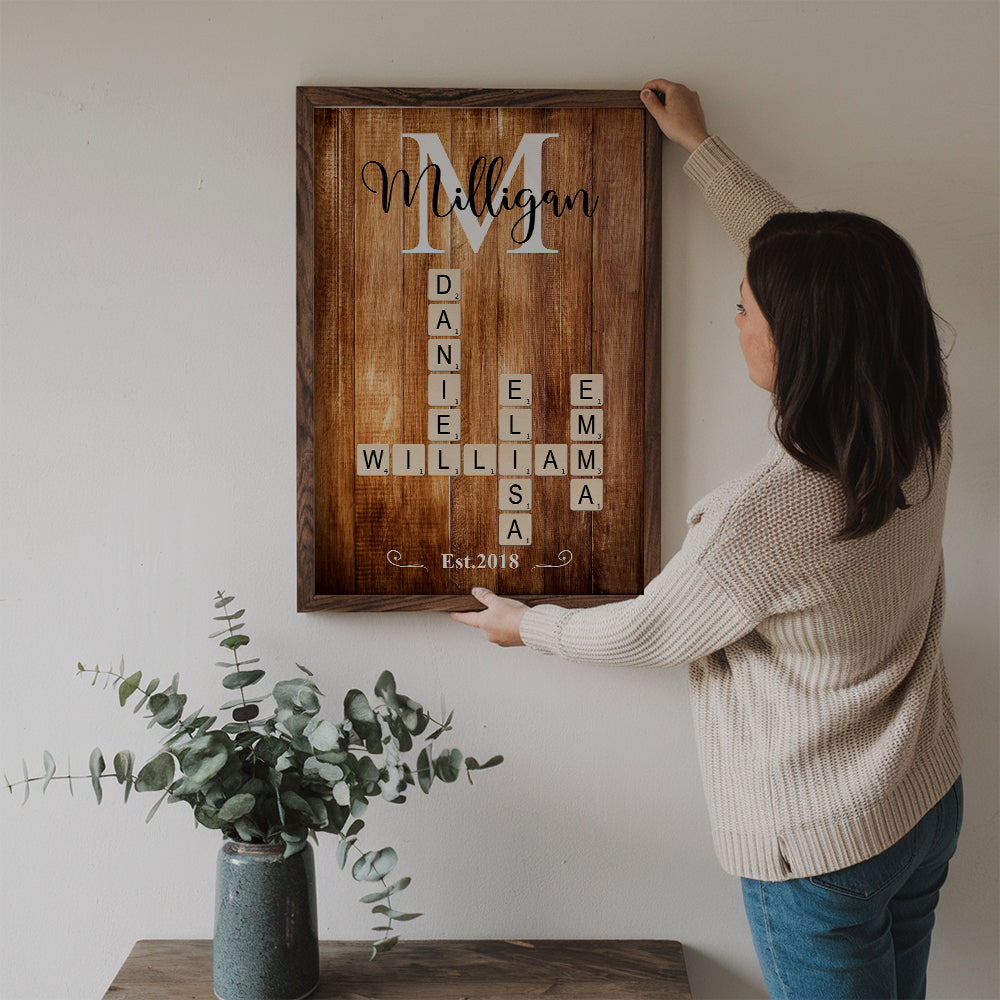 Personalized Family Name Crossword Puzzle Art canvas print, a woman hanging the framed print on a wall