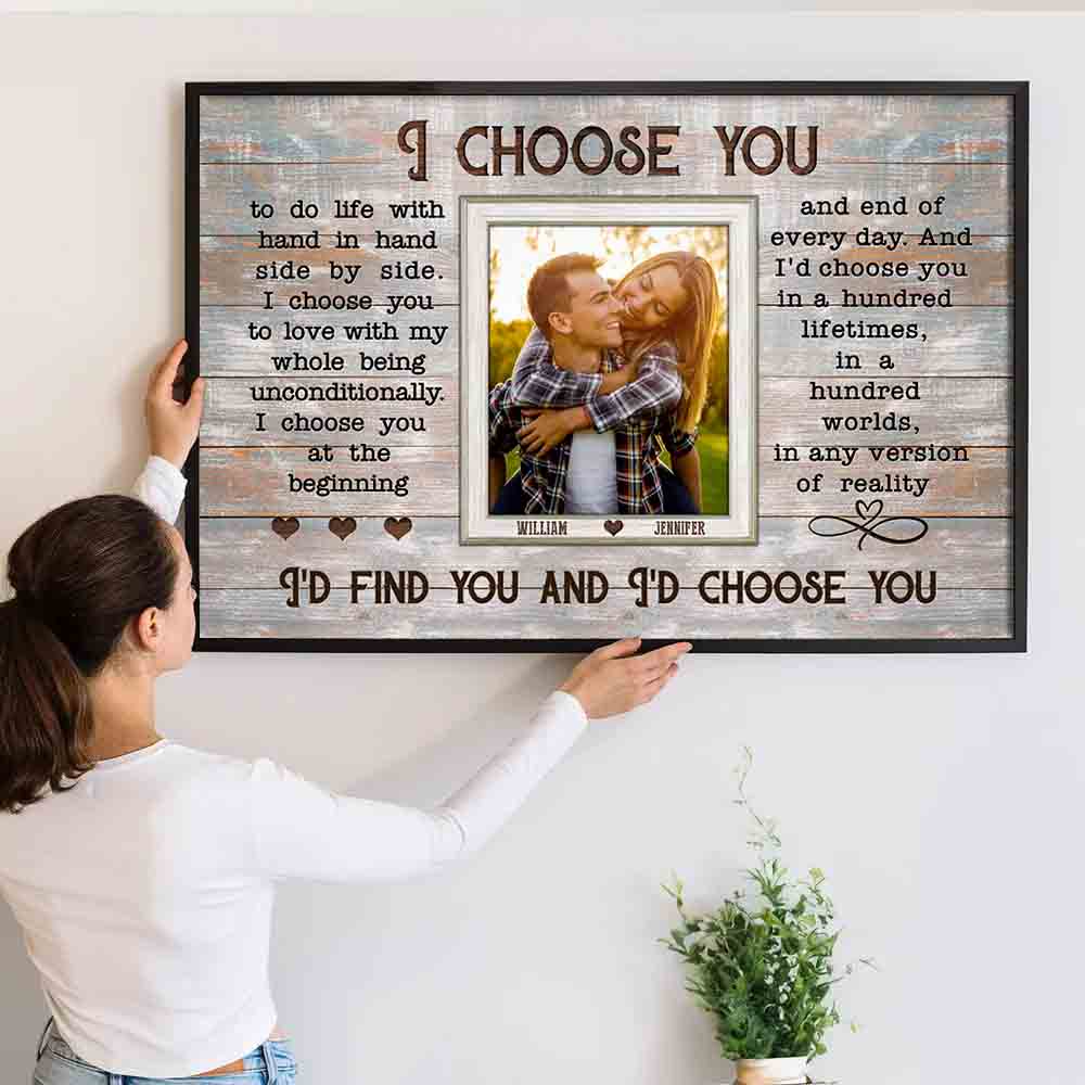 Couple's Custom Photo Wall Decor: Personalized "I Choose You" Canvas poster, a woman hanging the framed print on a wall