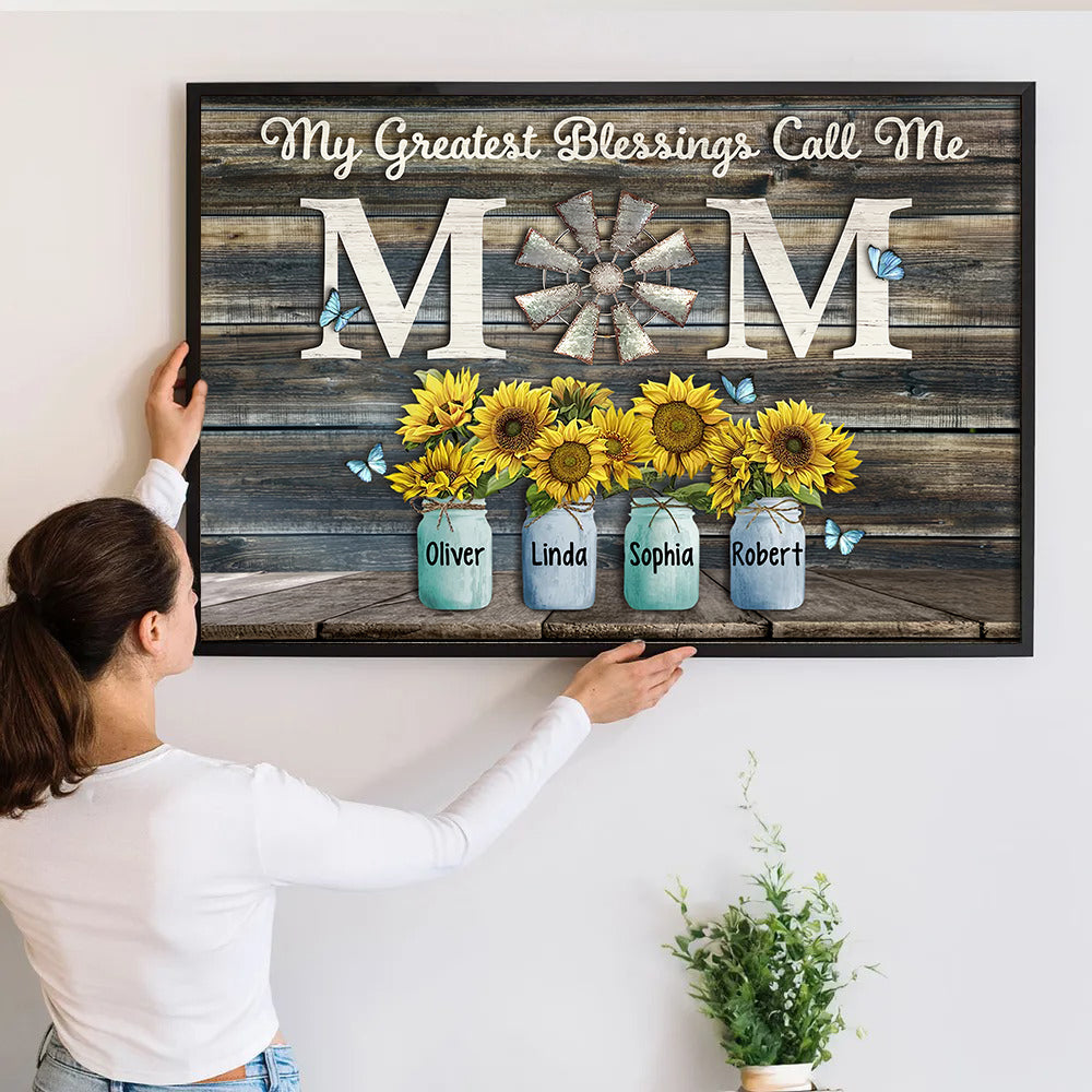 Personalized My Greatest Blessings Call Me Mom poster, a woman hanging the framed print on a wall