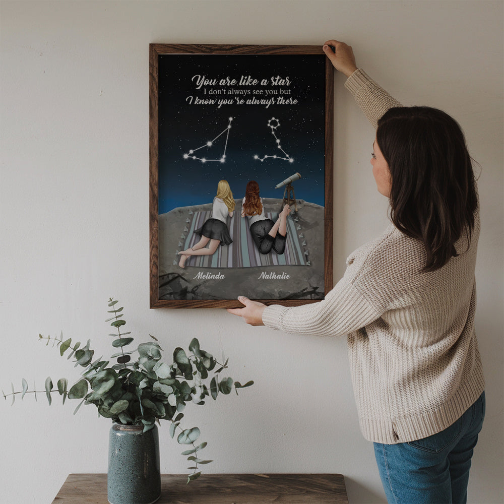 Personalized To My Bestie poster, a woman hanging the framed print on a wall