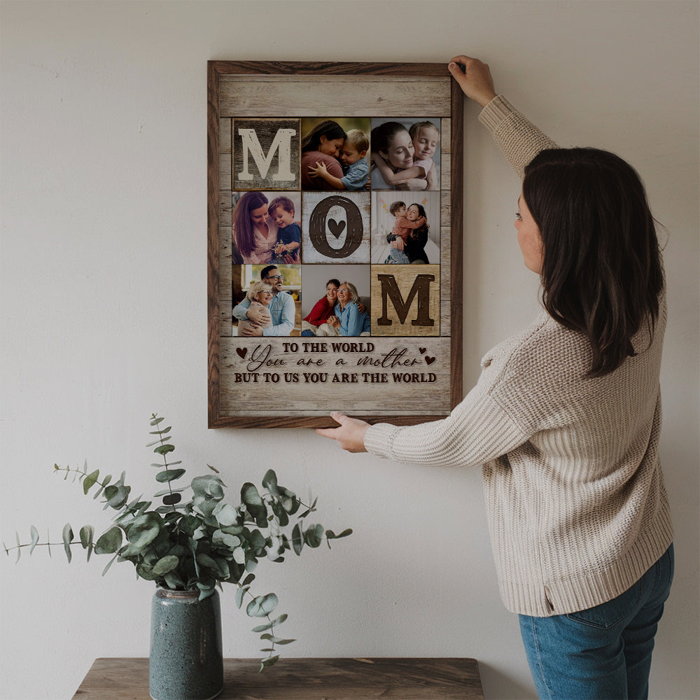 Custom Photo Collage Mom You Are The World poster, a woman hanging the framed print on a wall