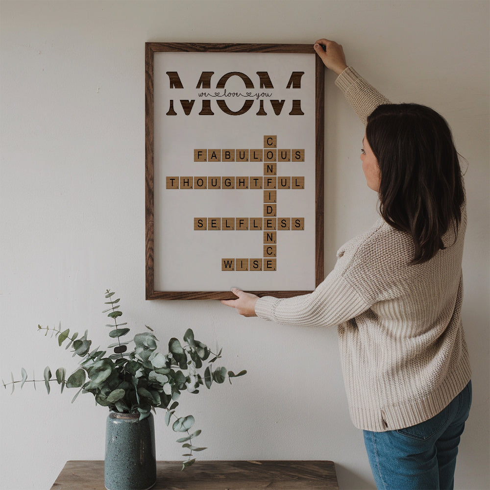 Personalized MOM Words Art Why We Love You Crossword Puzzle poster, a woman hanging the framed print on a wall