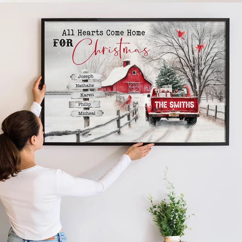 Personalized All Roads Lead Home At Christmas canvas print, a woman hanging the framed print on a wall