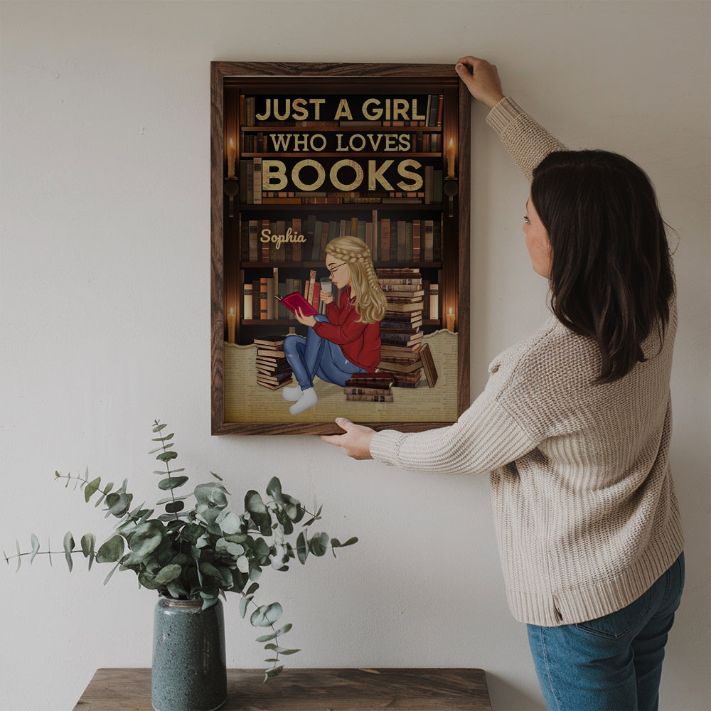Personalized Just A Girl Who Loves Books Reading canvas print, a woman hanging the framed print on a wall
