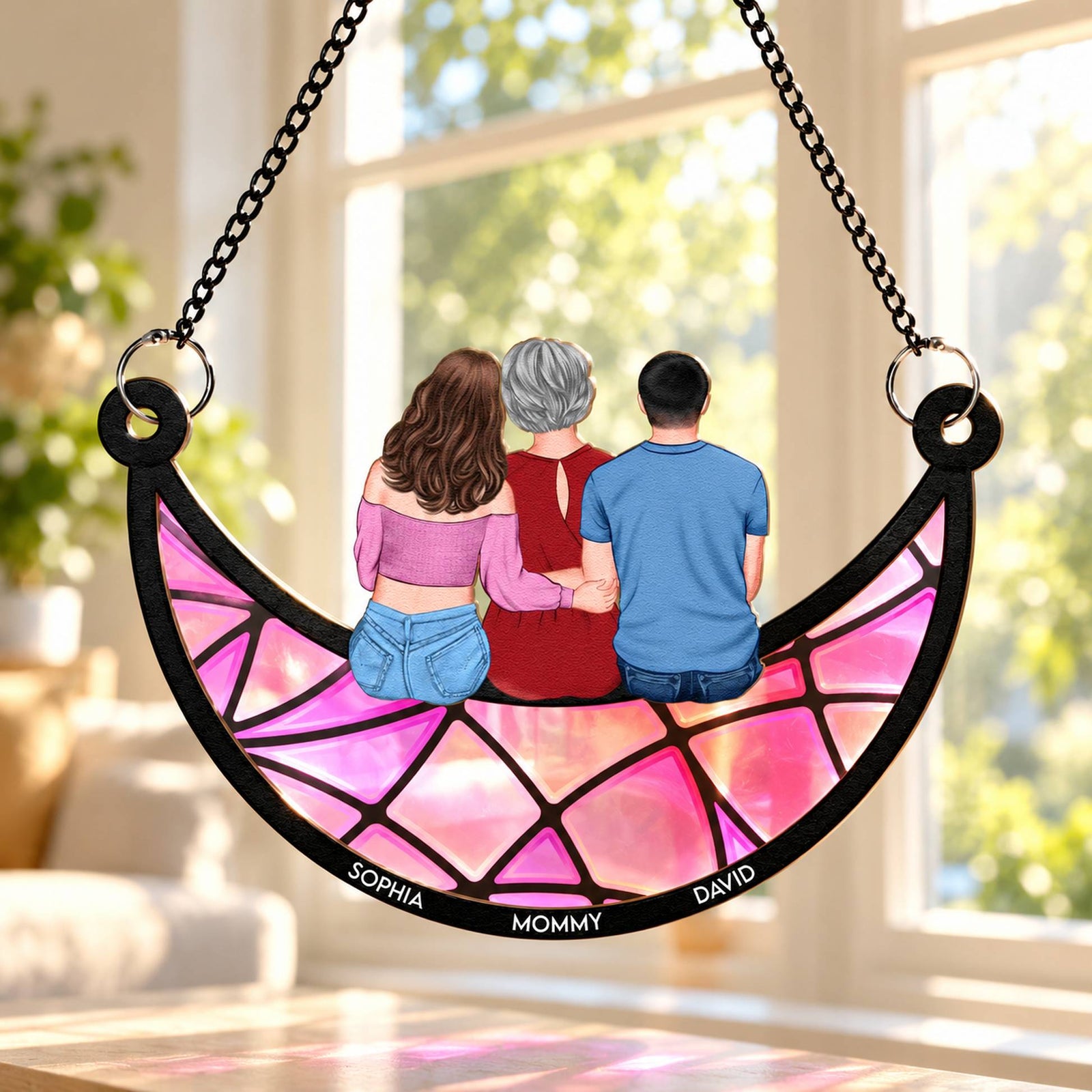 Personalized mom and children moon suncatcher hanging in a sunlit window