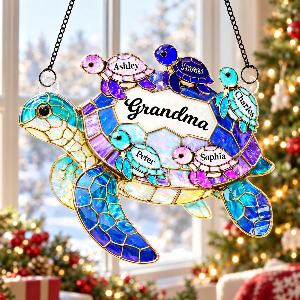 Personalized Grandma sea turtle suncatcher hanging in a bright holiday window with Christmas tree background