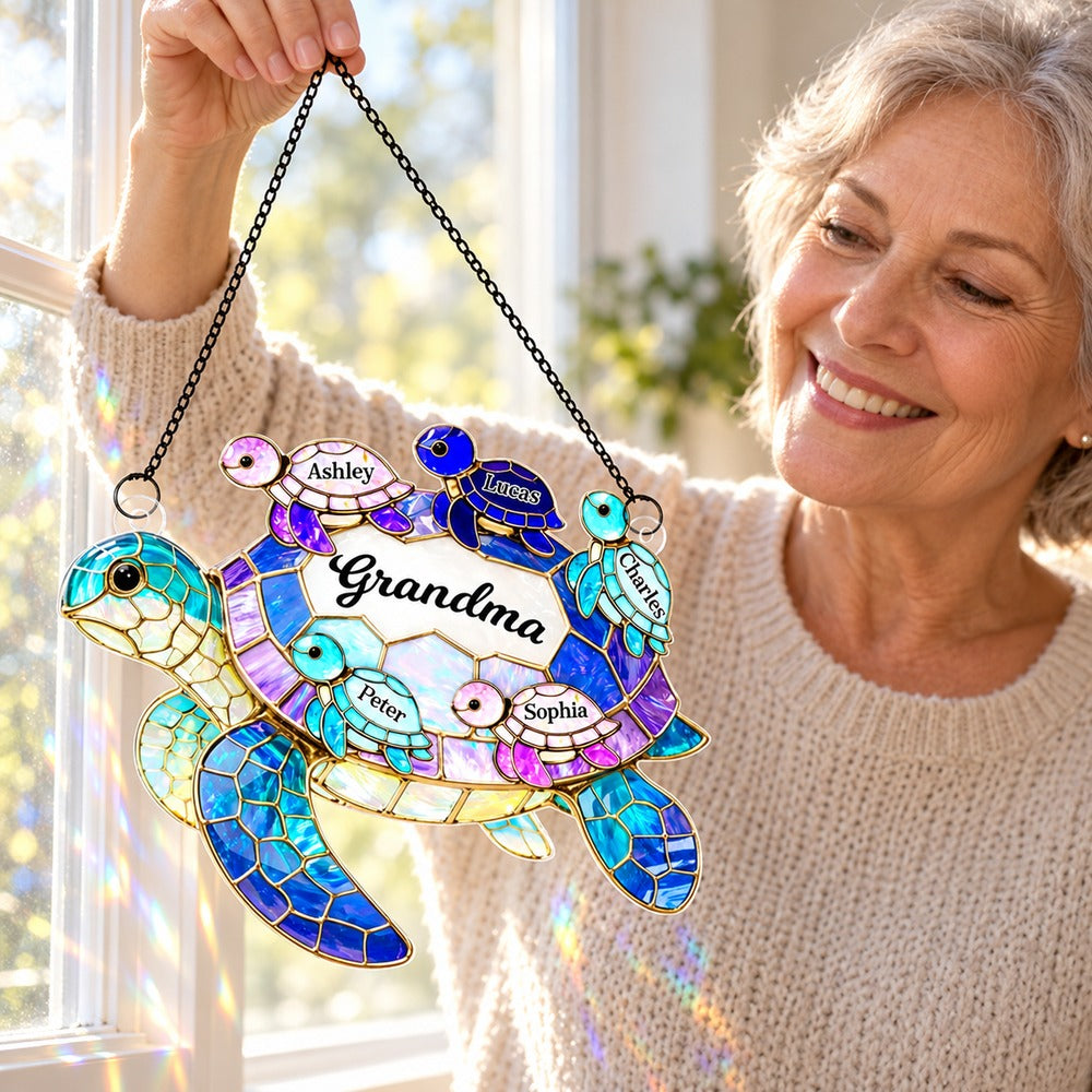 Happy grandmother holding her personalized sea turtle window suncatcher ornament with grandchildren names