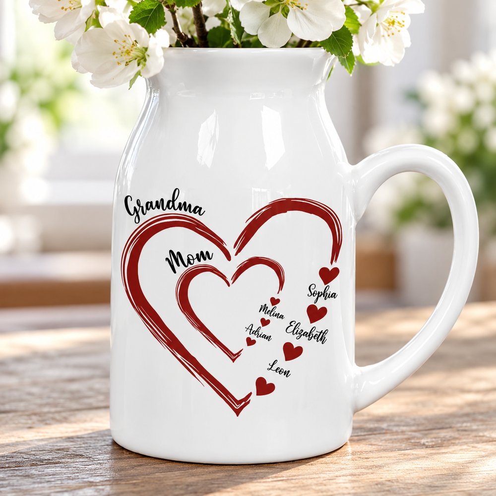 Close-up of printed heart and family names on glossy white ceramic flower vase