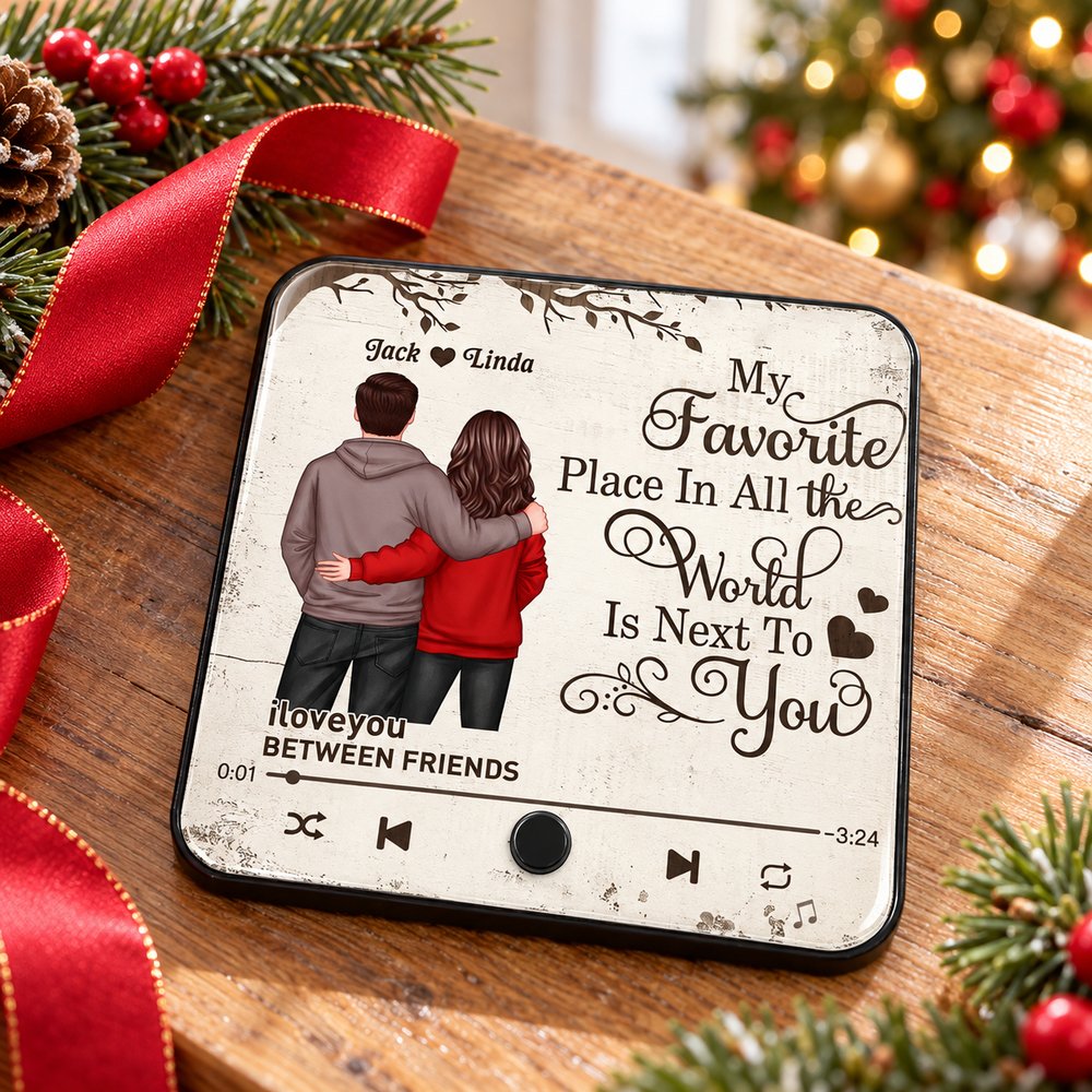 Personalized couple music fridge magnet lying flat on a holiday kitchen counter near pine sprigs