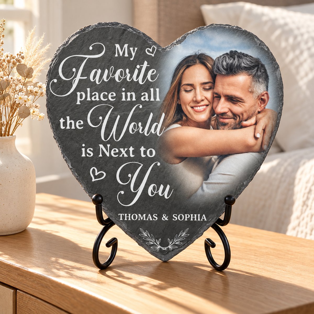 Custom couple photo heart slate stone on stand displayed on a wooden bedroom nightstand