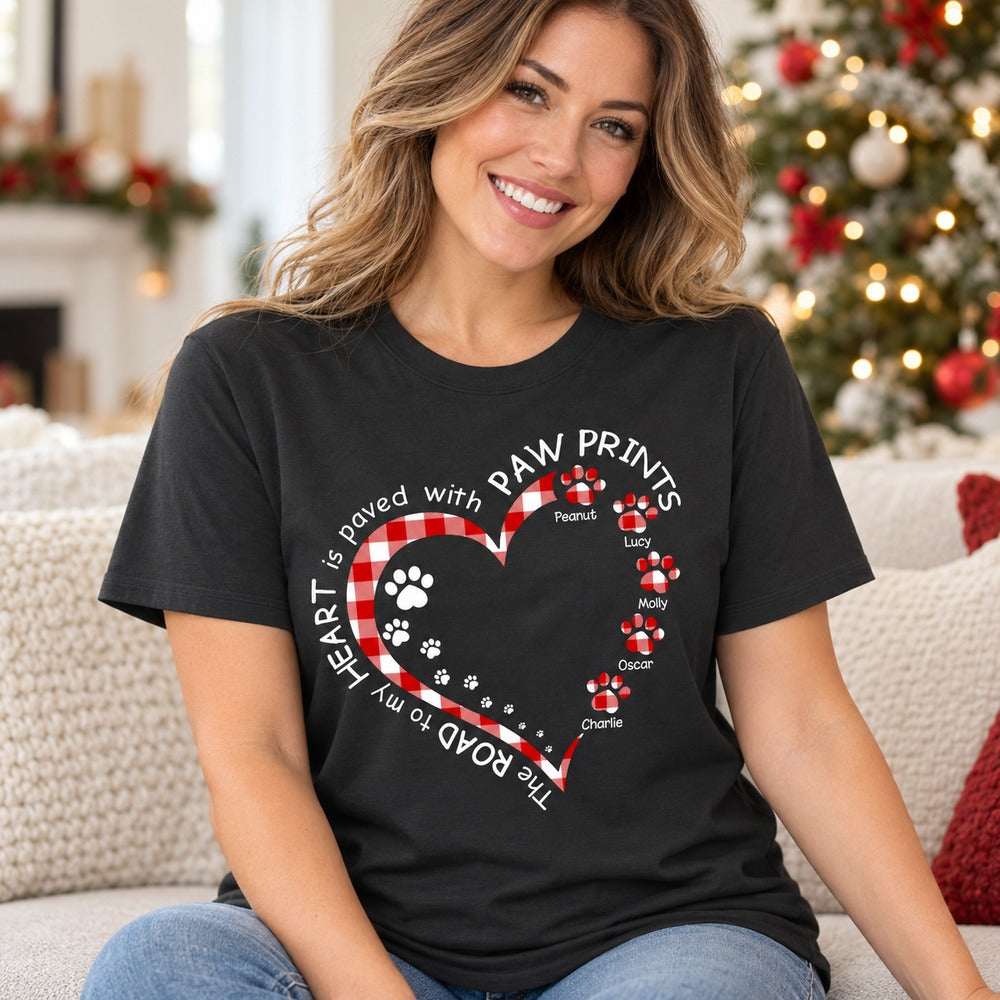 Dog mom wearing personalized paw print heart t-shirt on sofa near Christmas tree