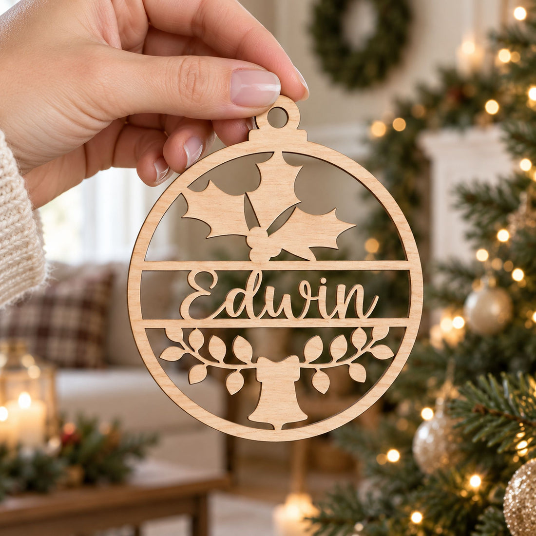 Woman holding a 4 inch personalized name wooden Christmas ornament to show scale