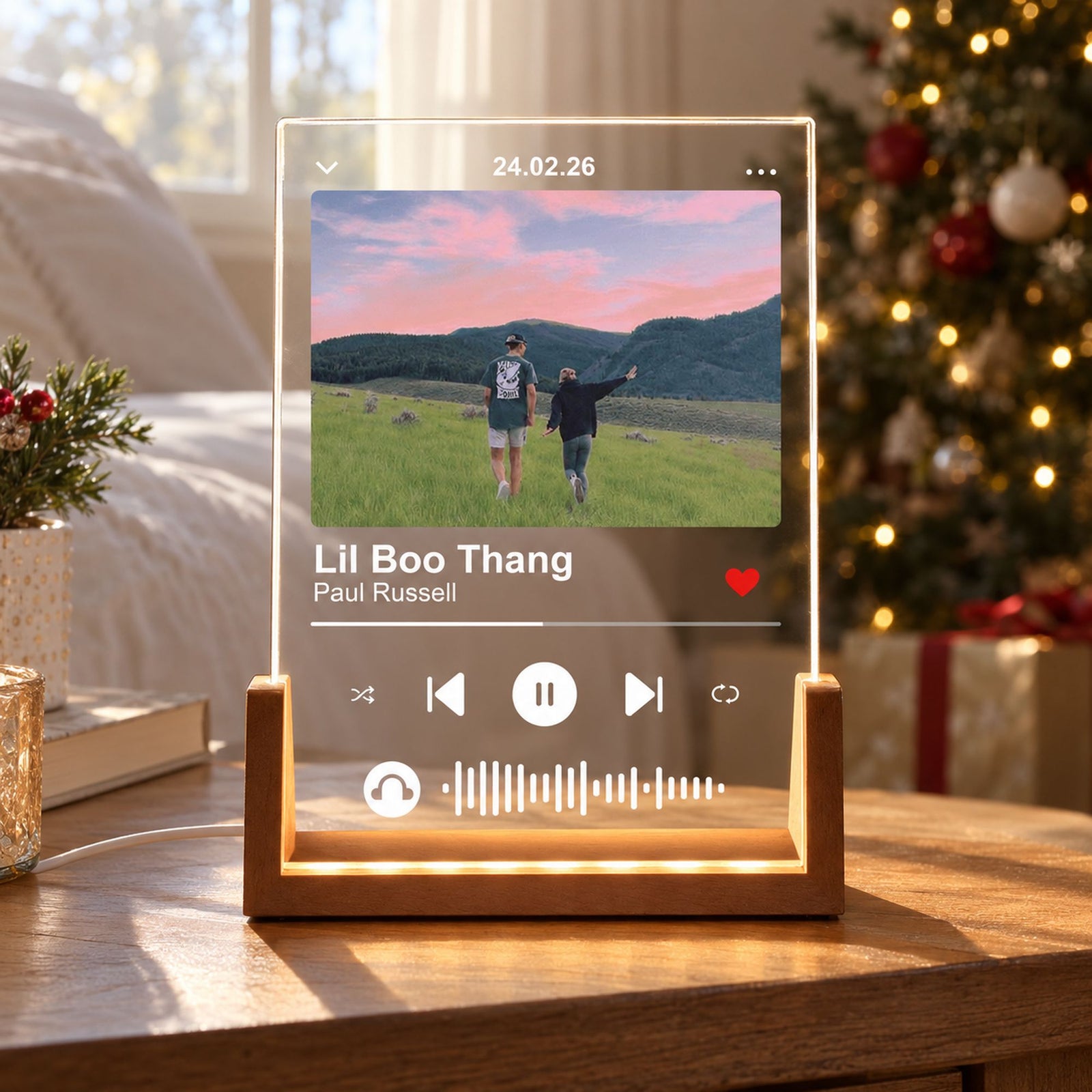 Personalized photo music plaque with U-shaped wooden LED base glowing on a bedroom nightstand near holiday decor