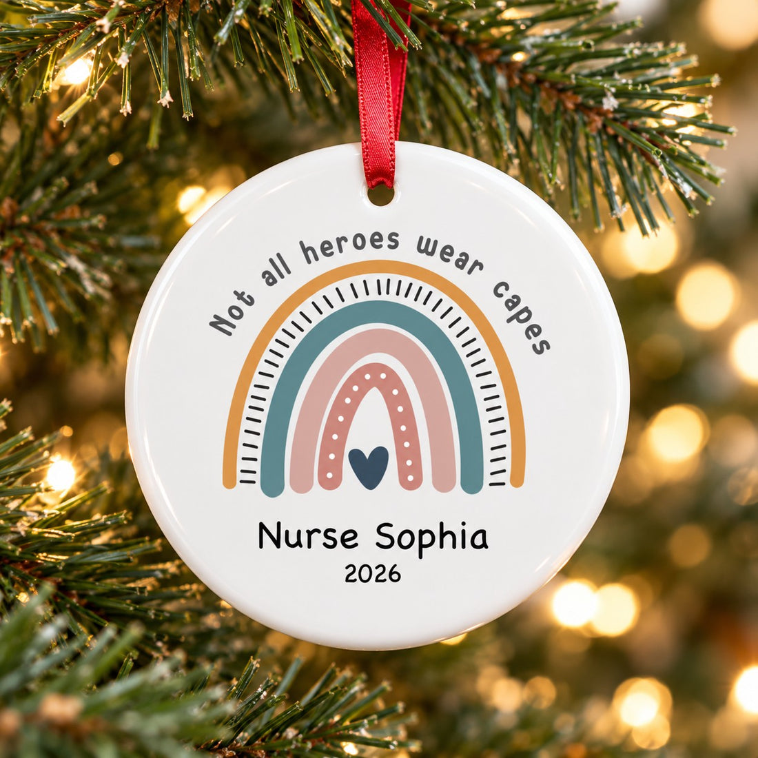 Personalized nurse circle ceramic ornament Nurse Sophia 2026 hanging on a green Christmas tree branch