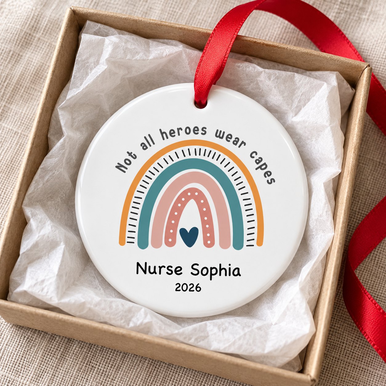 Personalized Nurse Sophia 2026 ceramic ornament nestled in a small gift box with white tissue paper