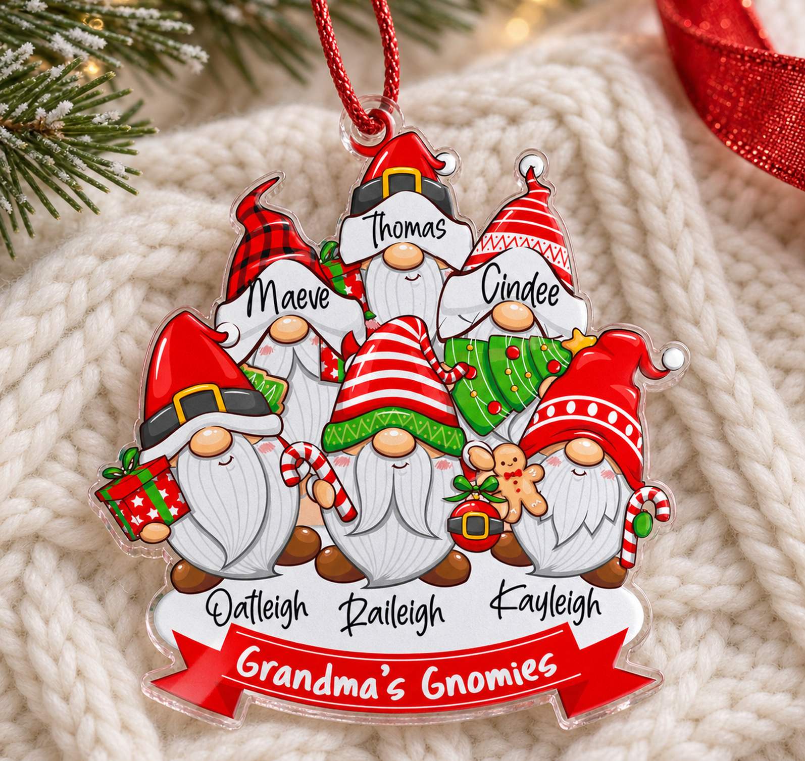 Personalized Grandma's Gnomies acrylic ornament lying flat on cozy holiday knit fabric