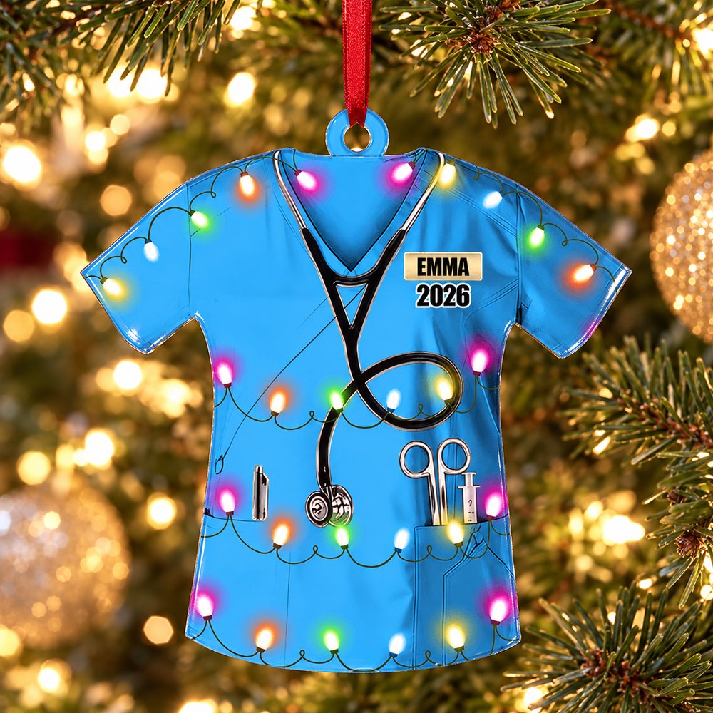 Personalized blue nurse uniform acrylic ornament hanging on a Christmas tree branch