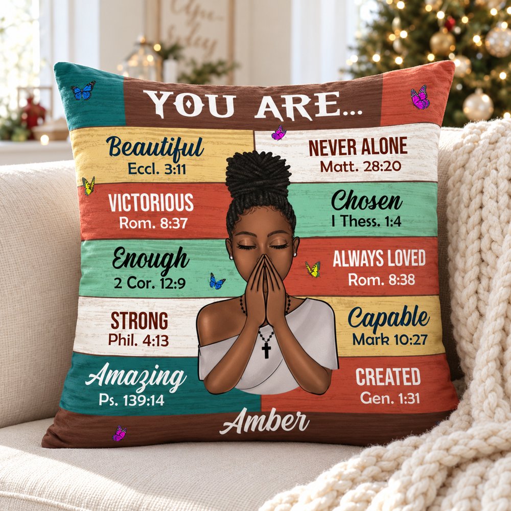 Personalized Bible Verses Christian pillow on a cozy cream sofa with holiday tree lights in background