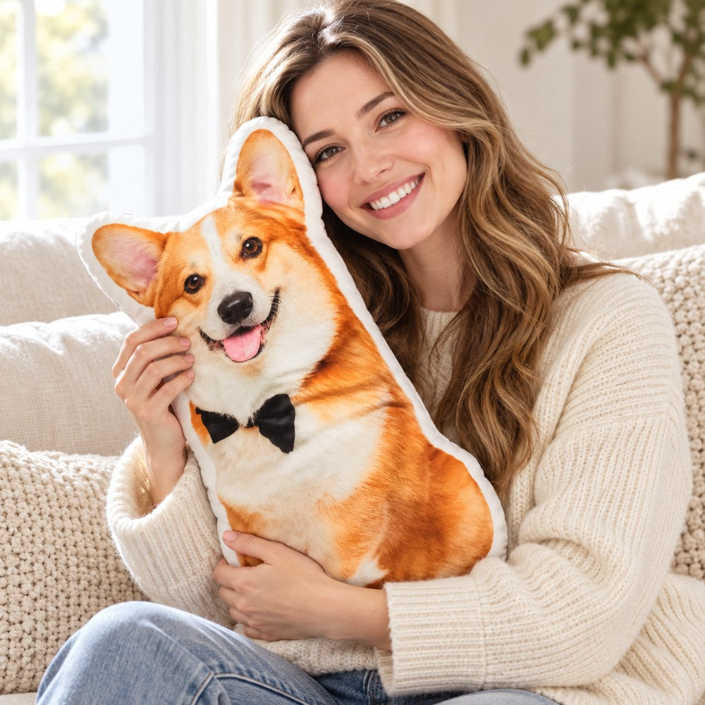 Dog lover hugging a personalized corgi shaped pet photo pillow on a bright couch