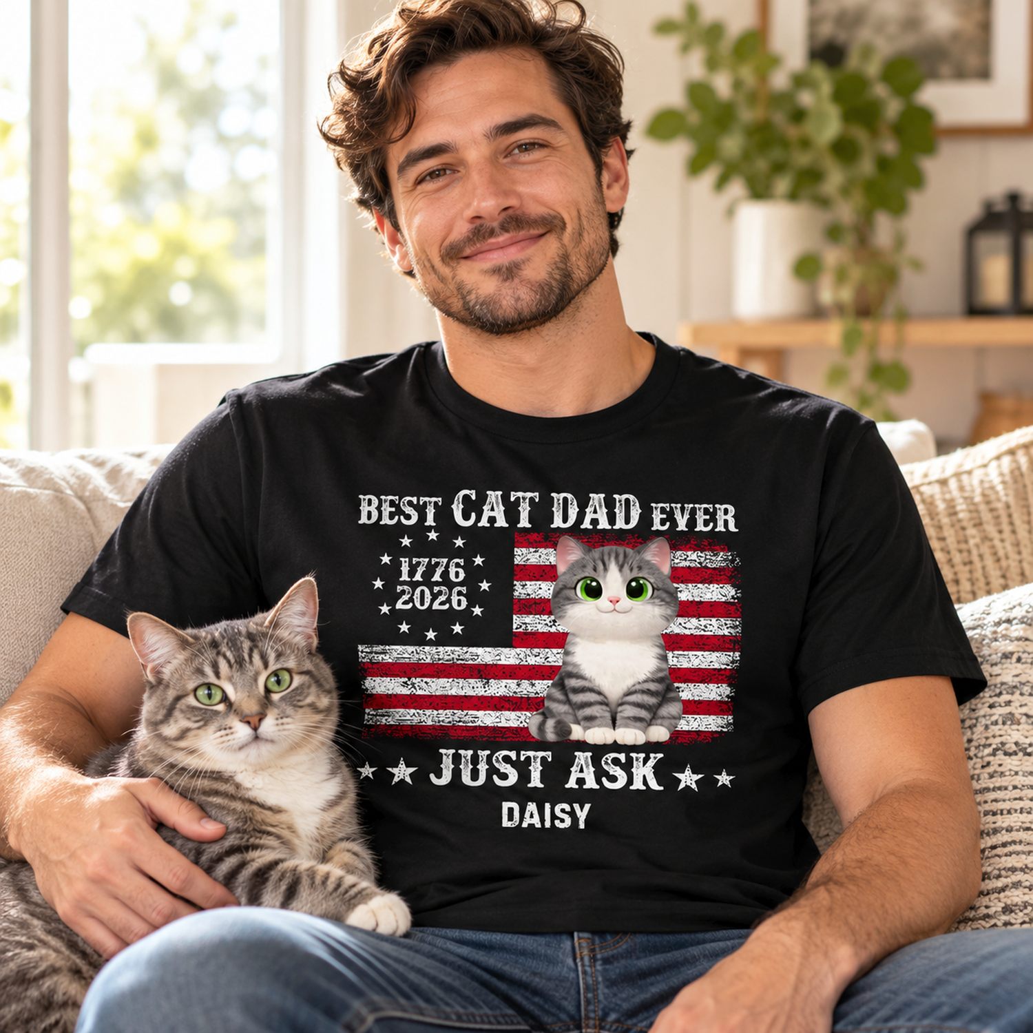 Man wearing Best Cat Dad Ever personalized t-shirt holding a cat on a bright sofa