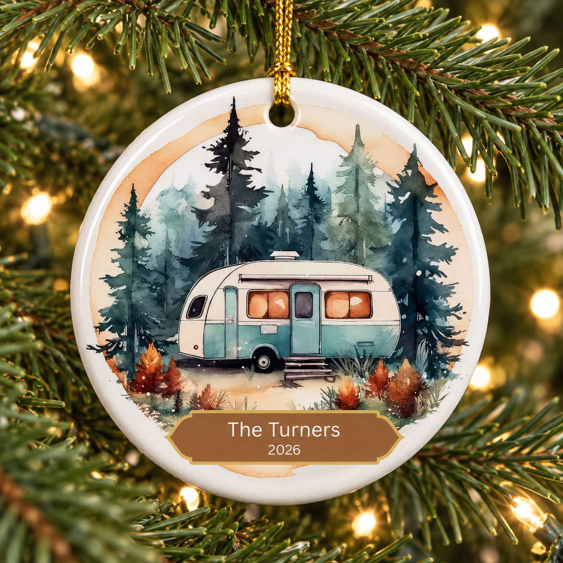 Personalized RV camping circle ceramic ornament hanging on a Christmas tree branch