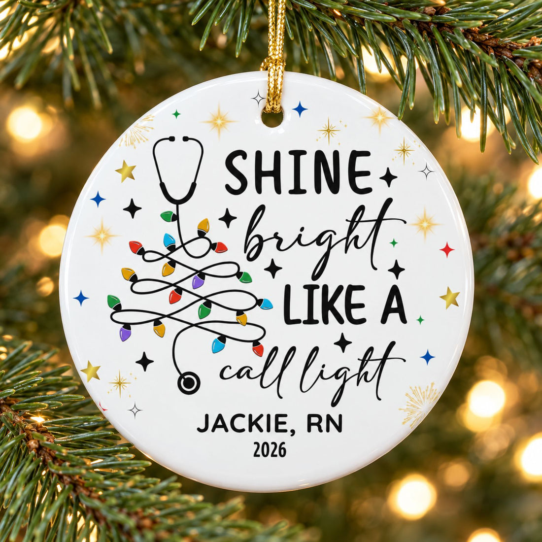 Shine Bright Like A Call Light nurse ceramic ornament hanging on a Christmas tree branch