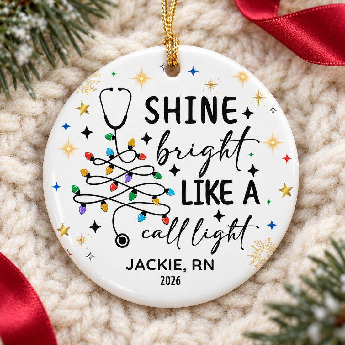 Personalized nurse circle ceramic ornament lying flat on a cream knit blanket with pine greenery