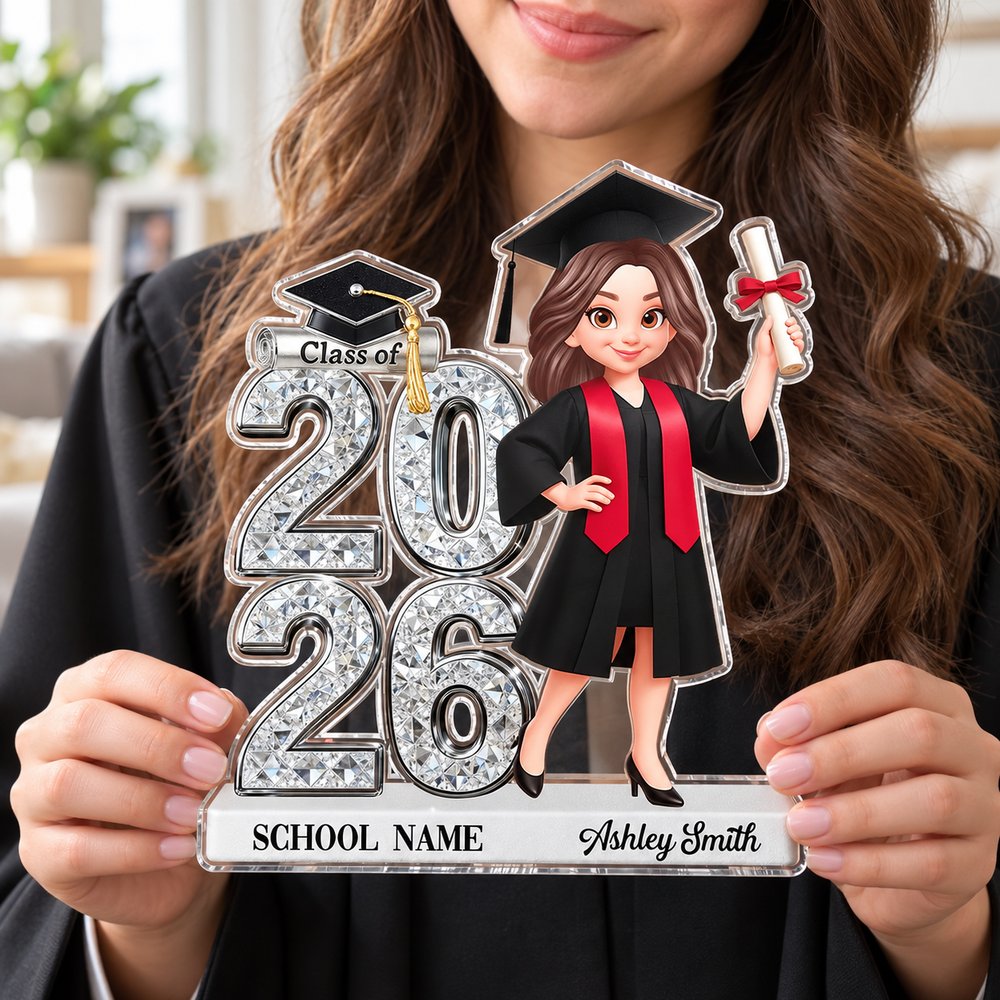 Young female graduate holding her personalized Class of 2026 senior acrylic plaque keepsake