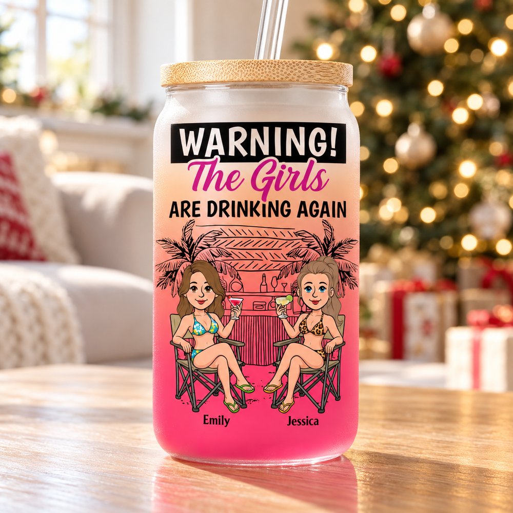 Personalized bestie glass cup on a wooden table with soft Christmas tree lights in background