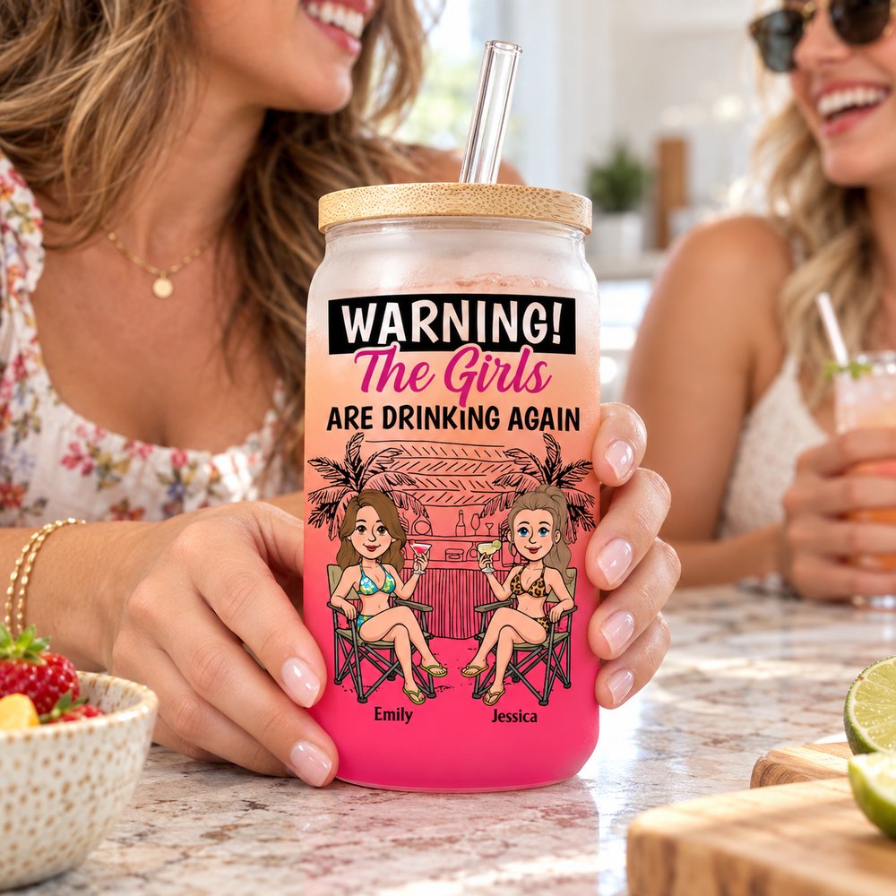 Woman holding personalized Warning The Girls Are Drinking Again glass cup with bamboo lid