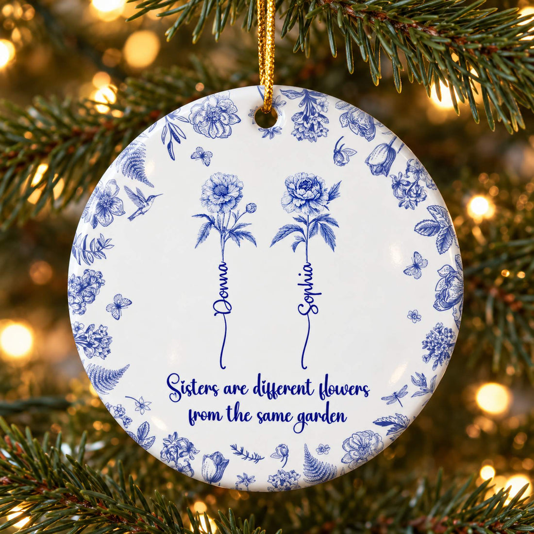 Sisters Toile De Jouy personalized circle ceramic ornament hanging on a Christmas tree branch