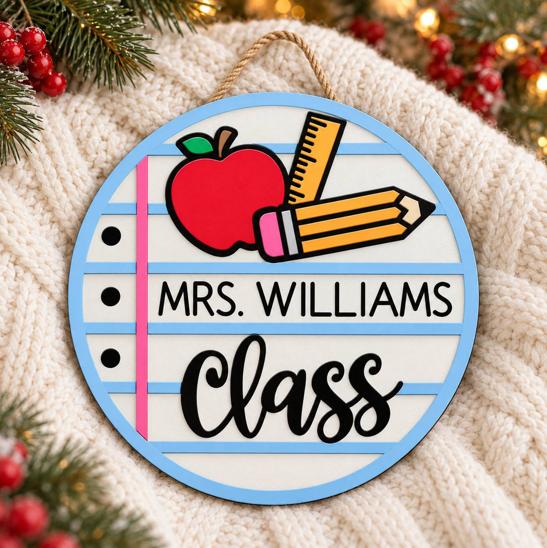 Personalized teacher round wood sign on a cozy knit blanket with holiday greenery