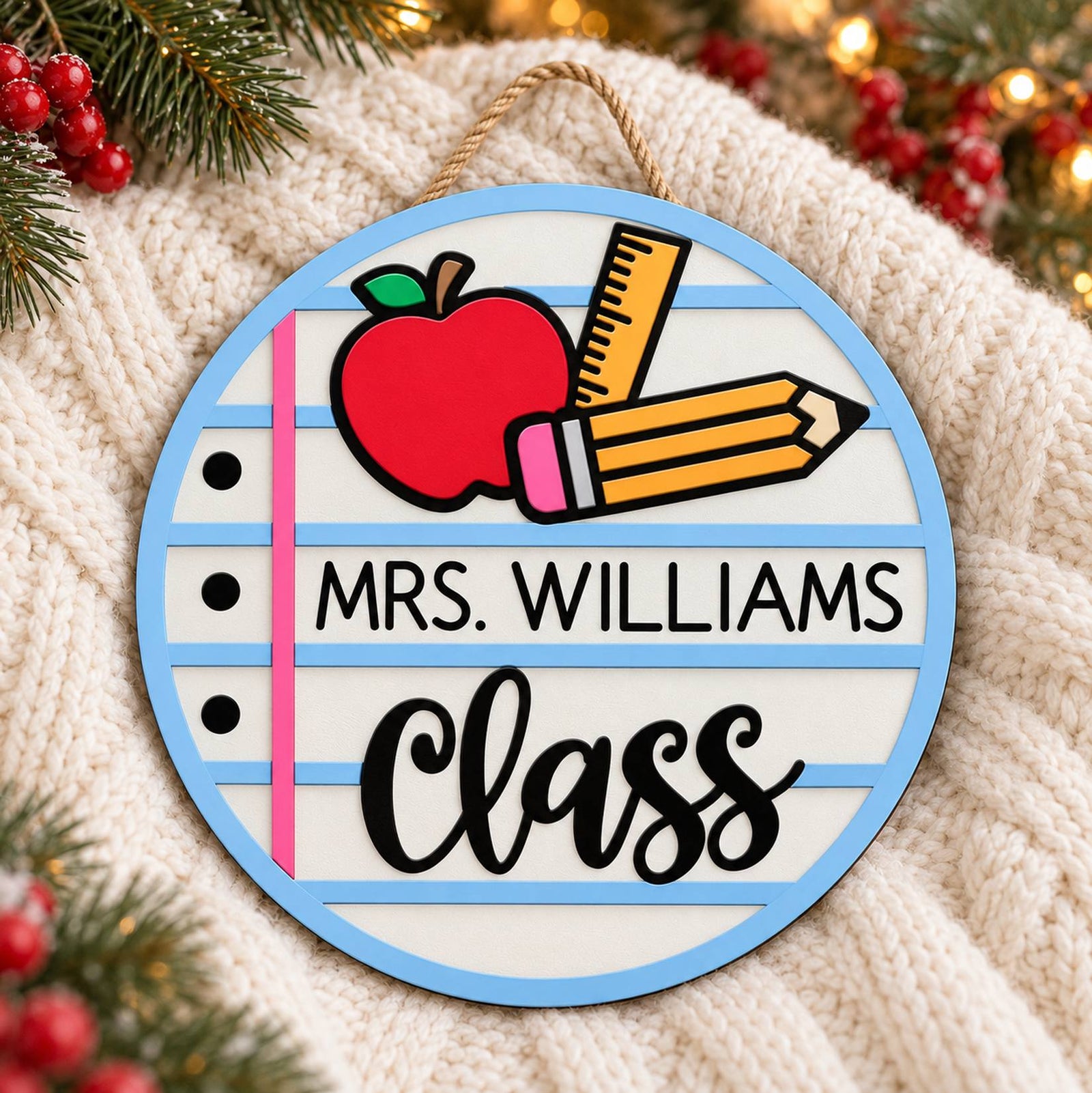 Personalized teacher round wood sign on a cozy knit blanket with holiday greenery