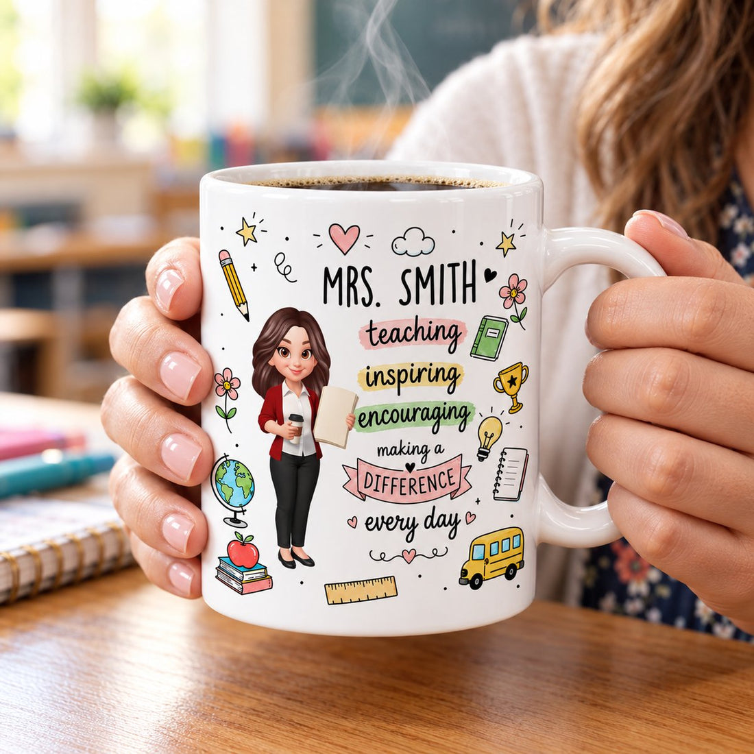 Personalized teacher ceramic mug held by a teacher with steaming coffee at a desk