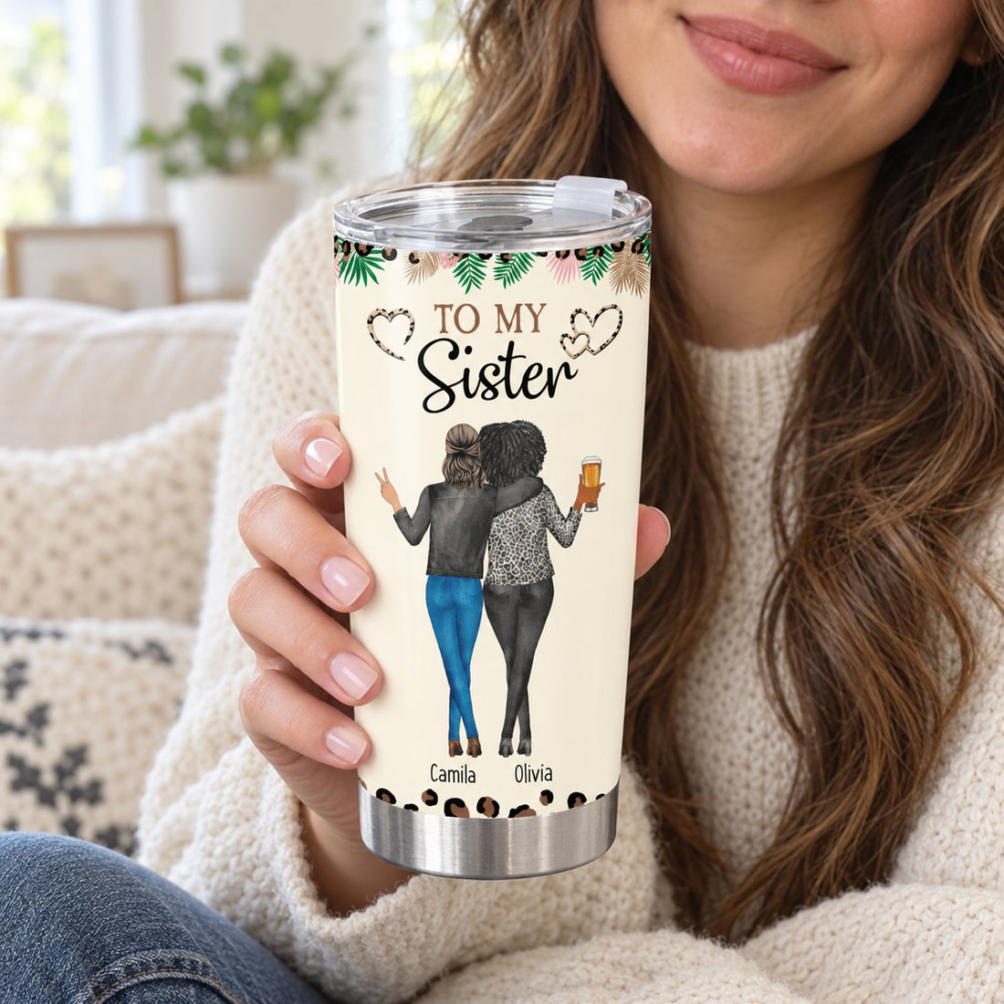 Woman holding personalized To My Sister 20oz fat tumbler cup on a cozy sofa