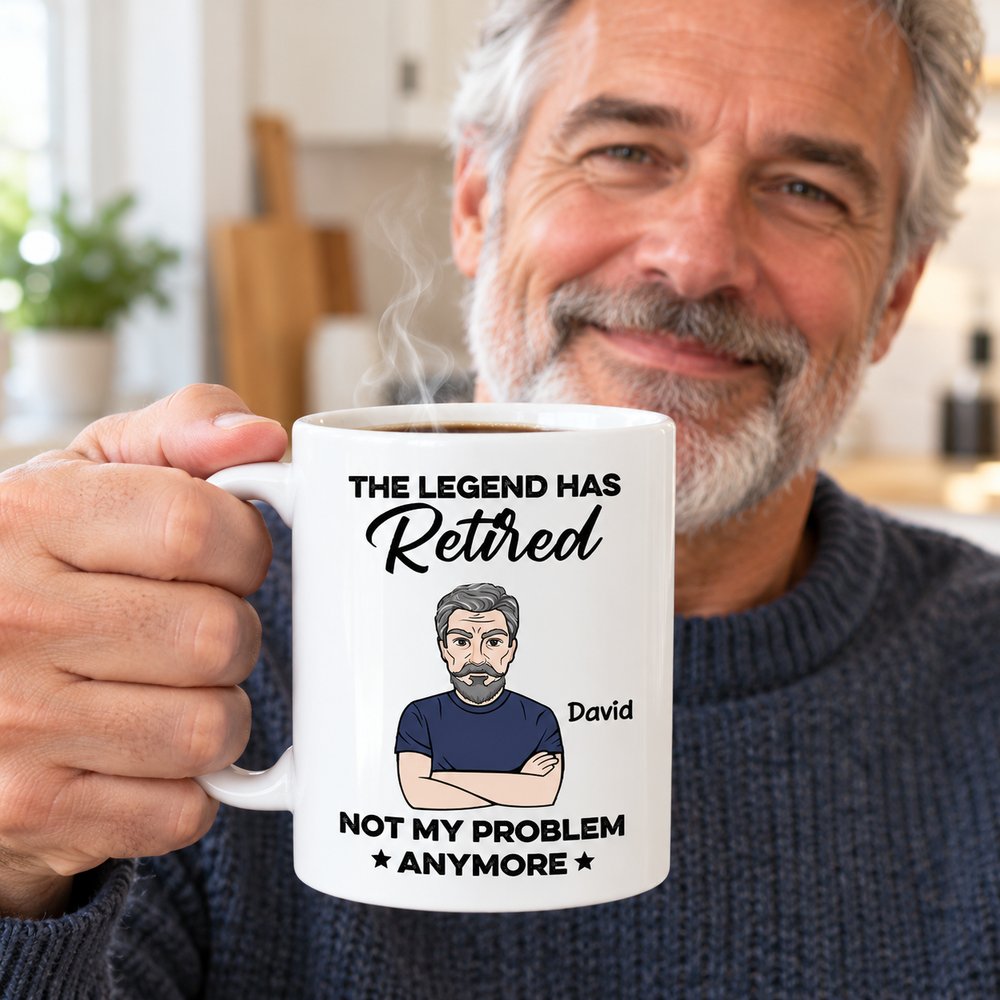 Retired man holding his personalized The Legend Has Retired coffee mug with steam rising